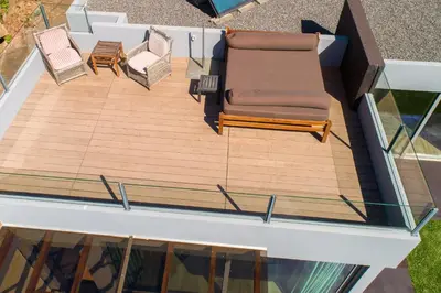 an overhead view of a deck with a couch and chairs at Calheta Tangerine House in Arco da Calheta