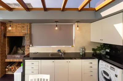 a kitchen with a sink and a stove at Calheta Tangerine House in Arco da Calheta
