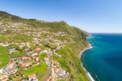 an aerial view of a village on a hill next to the ocean at Calheta Tangerine House in Arco da Calheta