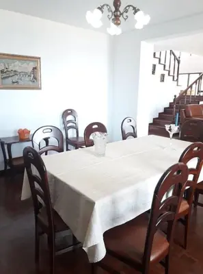 a dining room with a white table and chairs at Madeira Panoramic Villa- Promoção 2 ou 3 semana in Funchal