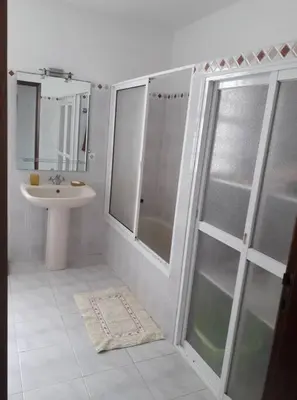a bathroom with a shower and a sink and a mirror at Madeira Panoramic Villa- Promoção 2 ou 3 semana in Funchal