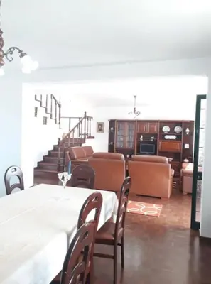 a dining room with a table and chairs and stairs at Madeira Panoramic Villa- Promoção 2 ou 3 semana in Funchal