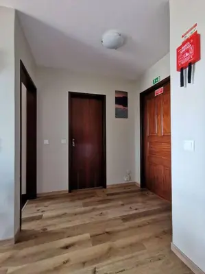 an empty room with two doors and a wooden floor at Alegria A in Funchal