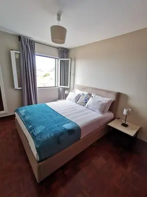 a bedroom with a large bed and a window at Alegria A in Funchal