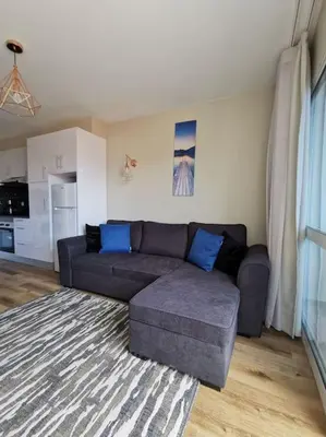 a living room with a couch and a kitchen at Alegria A in Funchal
