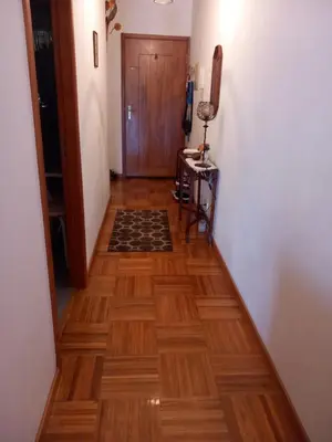 a hallway with a wooden floor and a door at Cantinho da Maria in Funchal
