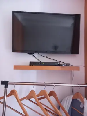 a flat screen tv hanging on a wall at Cantinho da Maria in Funchal