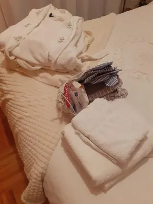 a pile of towels sitting on top of a bed at Cantinho da Maria in Funchal