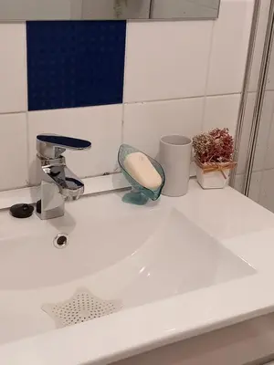 a white bathroom sink with a hair dryer on it at Cantinho da Maria in Funchal