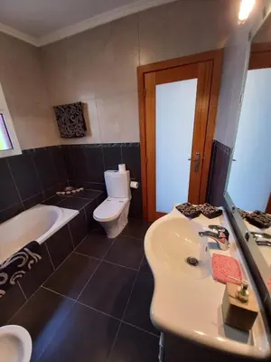 a bathroom with a sink and a toilet and a tub at Casa Abreu Gouveia in Ponta do Pargo in Calheta
