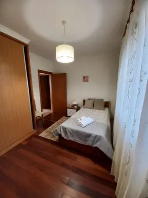 a bedroom with a bed and a large window at Casa Abreu Gouveia in Ponta do Pargo in Calheta