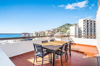a table and chairs on a balcony with a view of the ocean at Casa Branca 360 - Penthouse - By Wehost in Funchal
