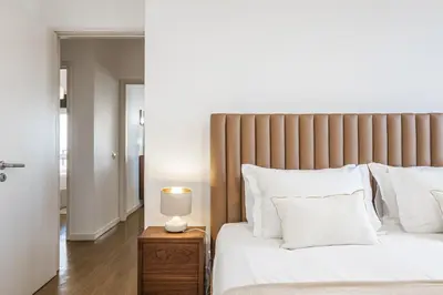 a bedroom with a bed and a lamp on a night stand at Casa Branca 360 - Penthouse - By Wehost in Funchal