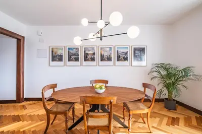 a dining room with a wooden table and chairs at Apartament 6 - By WeHost in Funchal
