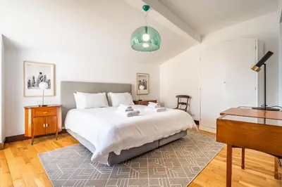 a bedroom with a large bed and a piano at Apartament 6 - By WeHost in Funchal