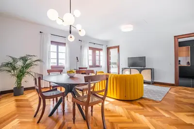 a dining room and living room with a table and chairs at Apartament 6 - By WeHost in Funchal