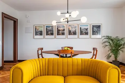 a yellow couch in a living room with a table at Apartament 6 - By WeHost in Funchal