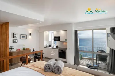 a bedroom with a view of the ocean at Premium quiet apt Funchal seafront Oceanbreeze in Funchal