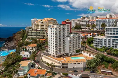 an aerial view of a city with buildings and the ocean at Premium quiet apt Funchal seafront Oceanbreeze in Funchal