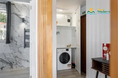 a laundry room with a washer and dryer at Premium quiet apt Funchal seafront Oceanbreeze in Funchal