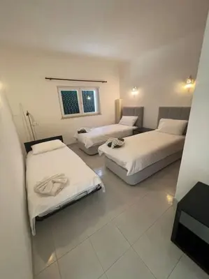 a room with two beds and a window at Casa Limonte in Luz