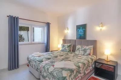a bedroom with a bed and a window at Casa Limonte in Luz