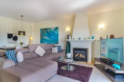 a living room with a couch and a fireplace at Casa Limonte in Luz