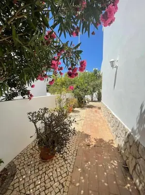 a brick walkway with potted plants next to a building at Casa Limonte in Luz