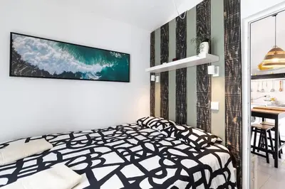 a bedroom with a black and white bed and a desk at Casa Levante in Sagres