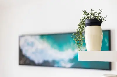 a vase with a plant in front of a tv at Casa Levante in Sagres
