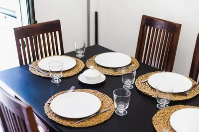 a black table with white plates and glasses on it at Casa Levante in Sagres