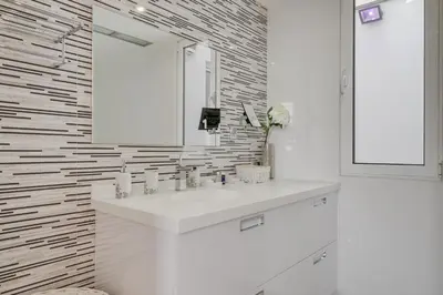 a white bathroom with a sink and a mirror at Casa Clarisse by Holiday Rental Madeira in Funchal