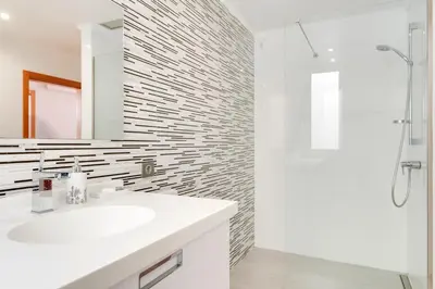 a white bathroom with a sink and a shower at Casa Clarisse by Holiday Rental Madeira in Funchal