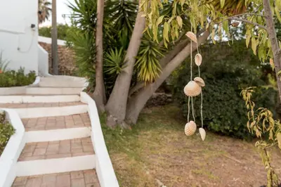 a yard with stairs and a tree with some ornaments at CoolHouses Algarve, Luz, 3 Bed villa, 1 bed studio, heated pool & jacuzzi, sea views, Casa Pequena in Luz