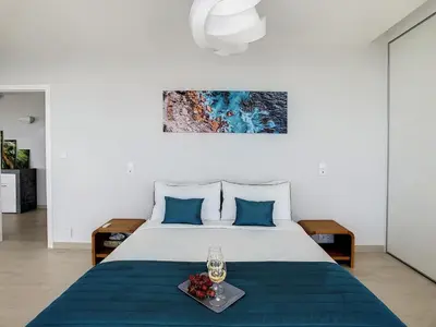 a bedroom with a large bed with blue pillows at Francelho 1 Apartment by LovelyStay in Ribeira Brava