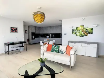 a living room with a white couch and a table at Francelho 1 Apartment by LovelyStay in Ribeira Brava