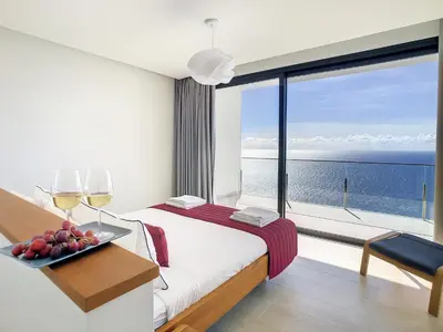 a hotel room with a bed and a view of the ocean at Francelho 2 Aparment by MHM in Ribeira Brava
