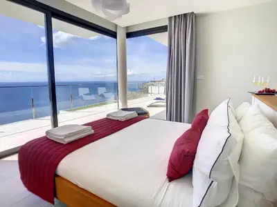 a bedroom with a large bed with a large window at Francelho 2 Aparment by MHM in Ribeira Brava