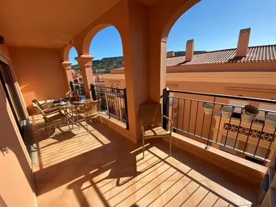 a balcony of a house with a table and chairs at Apartamento Dolce Vita in Luz