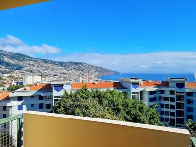 a view of a city with buildings and the ocean at Kiara's Cantinho do Mar by Rentallido in Funchal