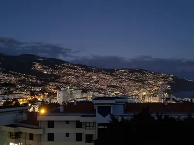 a view of a city at night at Kiara's Cantinho do Mar by Rentallido in Funchal