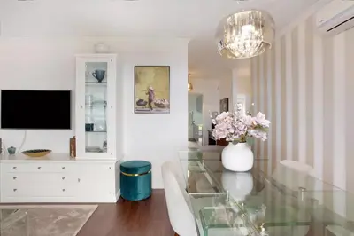 a living room with a glass table and a tv at Kiara's Cantinho do Mar by Rentallido in Funchal