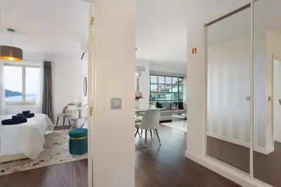 a bedroom with a large glass door leading to a dining room at Kiara's Cantinho do Mar by Rentallido in Funchal