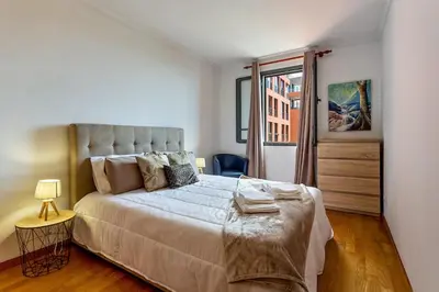 a bedroom with a large bed and a window at MCR Funchal in Funchal