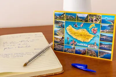 a pen and notebook sitting on a desk next to a book at MCR Funchal in Funchal