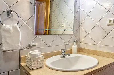a bathroom with a sink and a mirror at MCR Funchal in Funchal