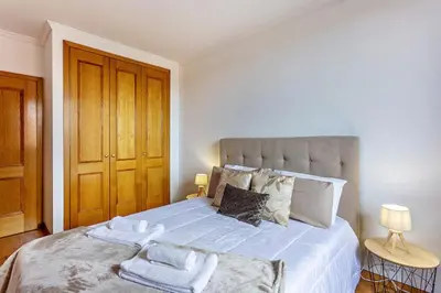 a bedroom with a large bed with towels on it at MCR Funchal in Funchal