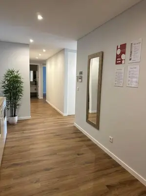 a hallway of an office with a mirror and wood floors at Deluxe Bay View in Câmara de Lobos