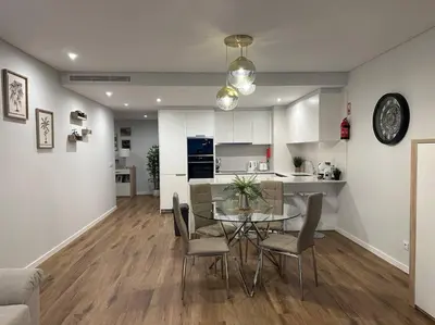 a dining room and kitchen with a table and chairs at Deluxe Bay View in Câmara de Lobos