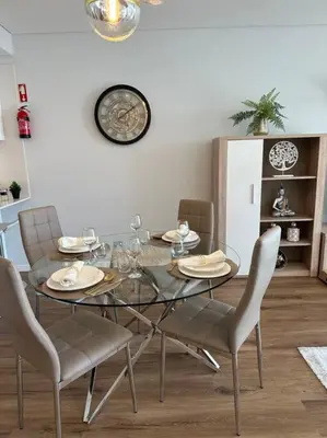 a dining room with a glass table and chairs at Deluxe Bay View in Câmara de Lobos